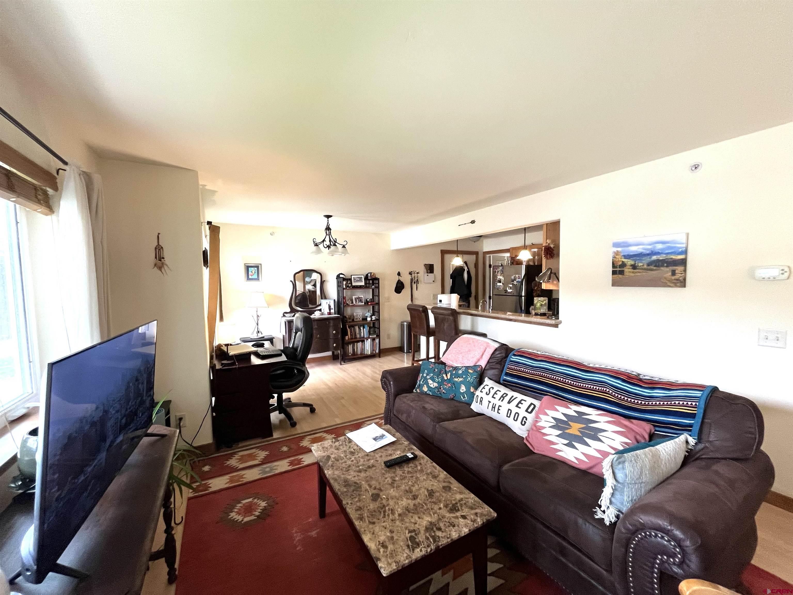 540 Redcliff Circle, Unit E104 Ridgway, CO 81432 - Photo 7 of 13 a living room with furniture and a table