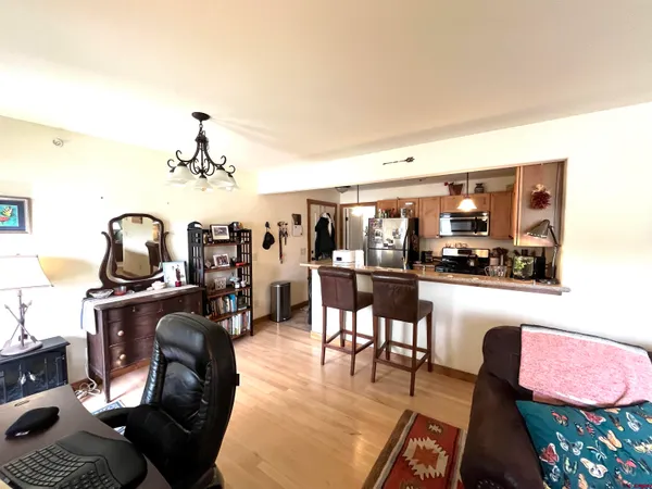 a bedroom with a bed a mirror and lamp next to a window