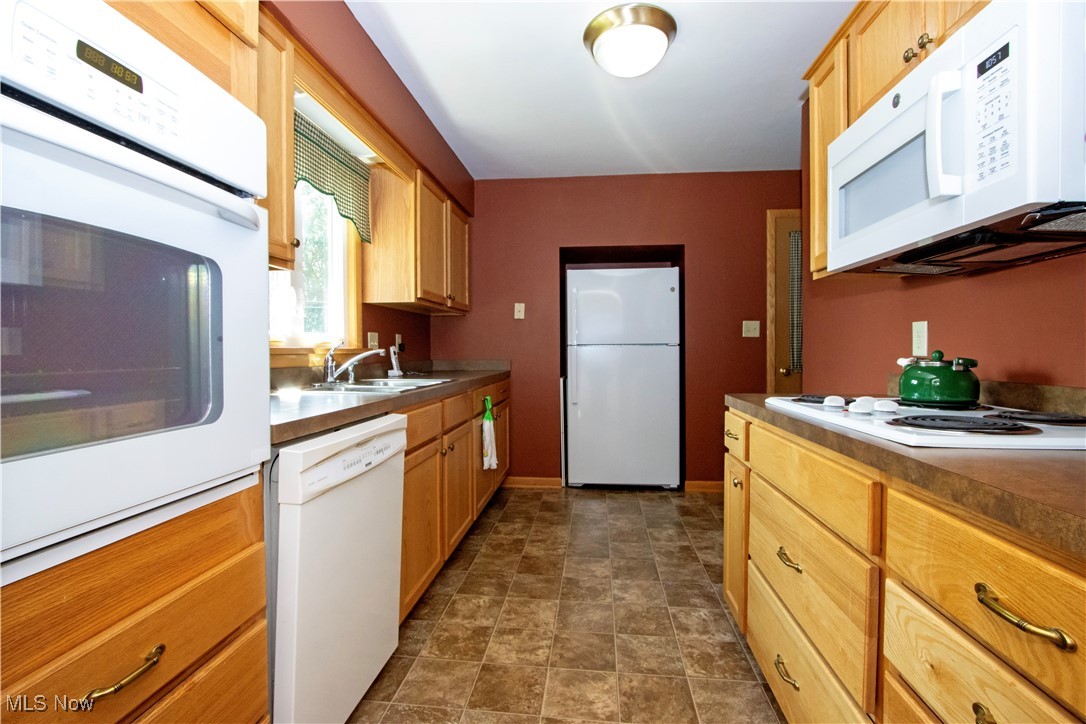 2456 Batdorf Road Wooster, OH 44691 - Photo 14 of 22 Kitchen with white appliances and stone finish flooring