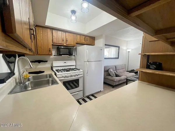 a kitchen with furniture a flat screen tv and a stove