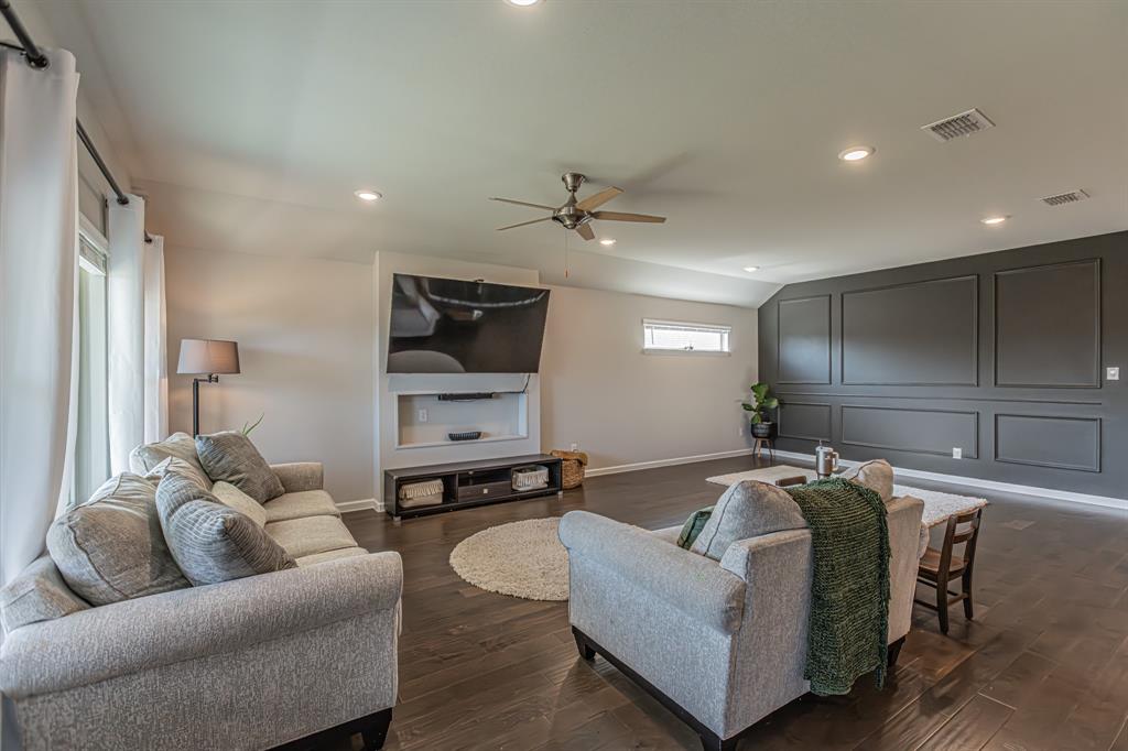 10269 Hanks Creek Road Fort Worth, TX 76126 - Photo 22 of 40 a living room with furniture and a flat screen tv
