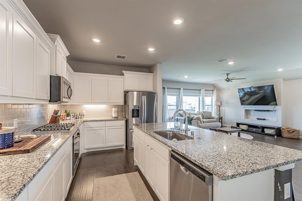 10269 Hanks Creek Road Fort Worth, TX 76126 - Photo 30 of 40 a kitchen with a sink stove cabinets and refrigerator