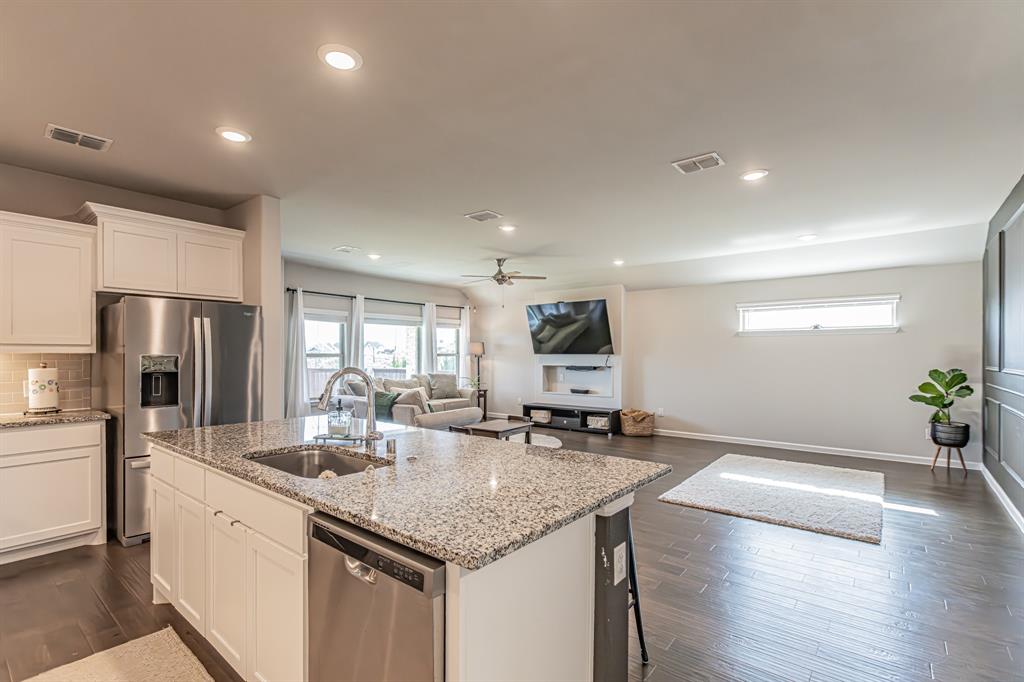 10269 Hanks Creek Road Fort Worth, TX 76126 - Photo 31 of 40 a kitchen with stainless steel appliances granite countertop a sink cabinets and wooden floor