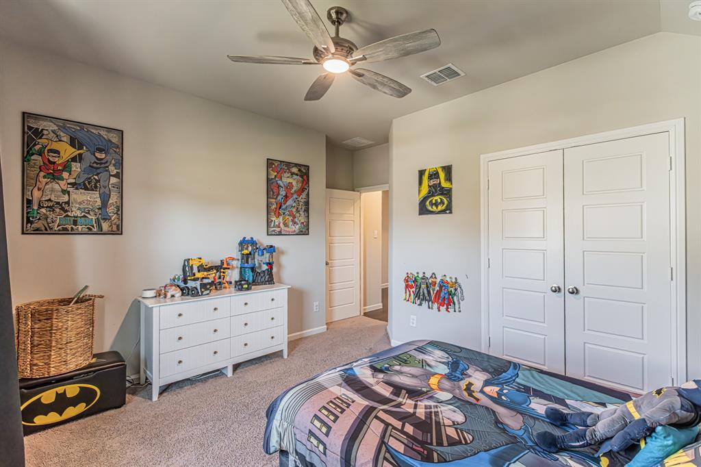 10269 Hanks Creek Road Fort Worth, TX 76126 - Photo 5 of 40 a bedroom with a bed and a chandelier