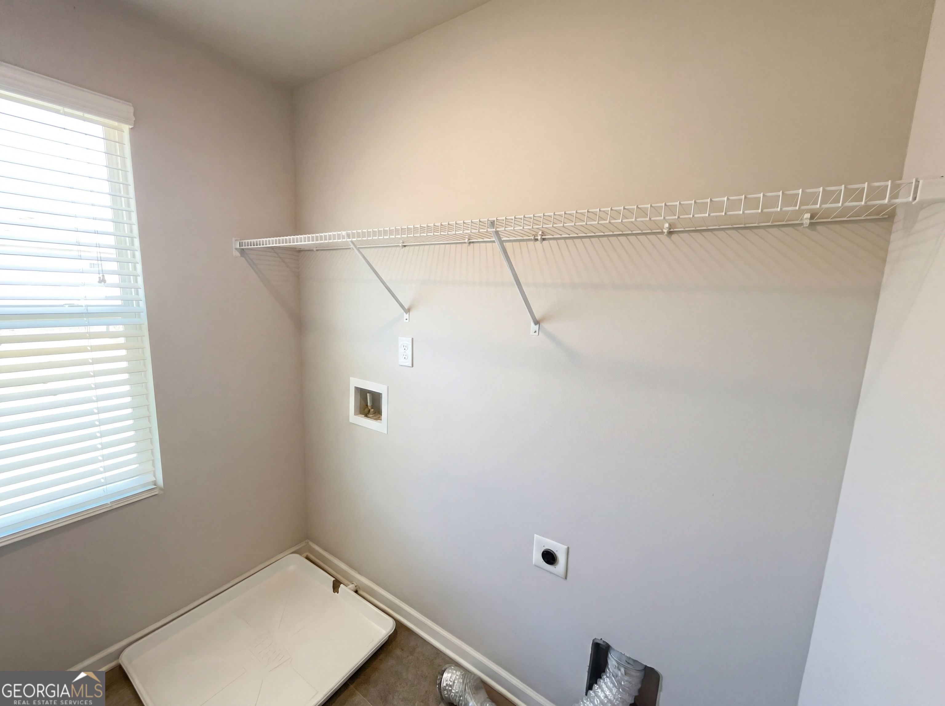 981 Fellowship Road, Unit 108 Fairburn, GA 30213 - Photo 14 of 21 a view of a room with racks on the wall