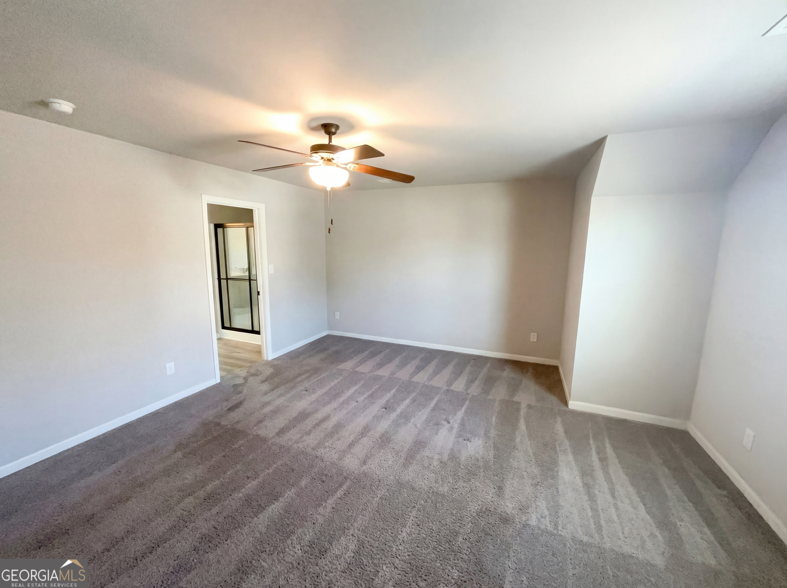 981 Fellowship Road, Unit 108 Fairburn, GA 30213 - Photo 4 of 21 wooden floor in an empty room with a window