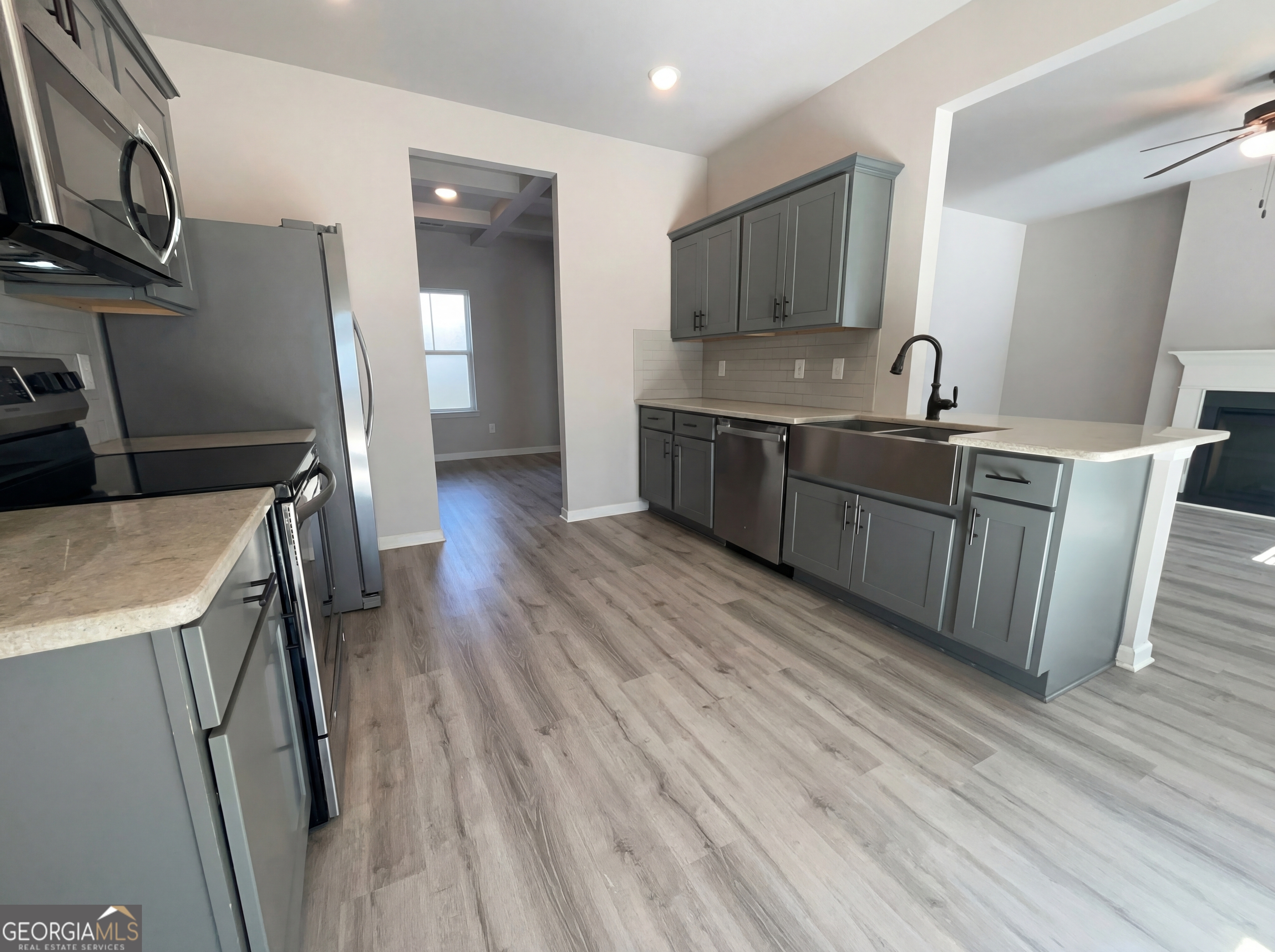 981 Fellowship Road, Unit 108 Fairburn, GA 30213 - Photo 6 of 21 a kitchen with stainless steel appliances granite countertop a sink a stove a refrigerator and cabinets