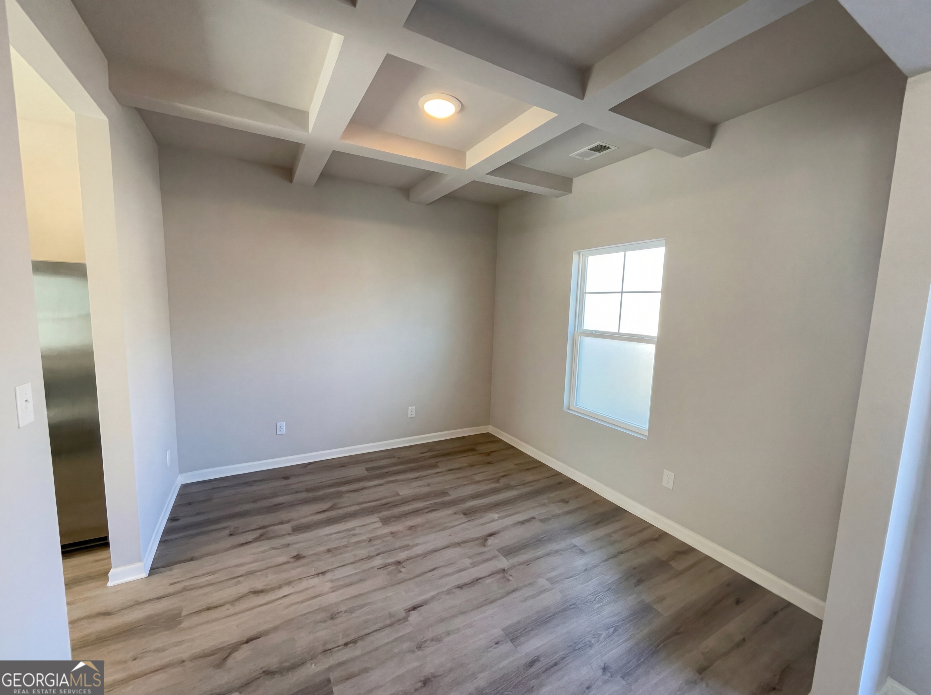 981 Fellowship Road, Unit 108 Fairburn, GA 30213 - Photo 8 of 21 an empty room with wooden floor and windows