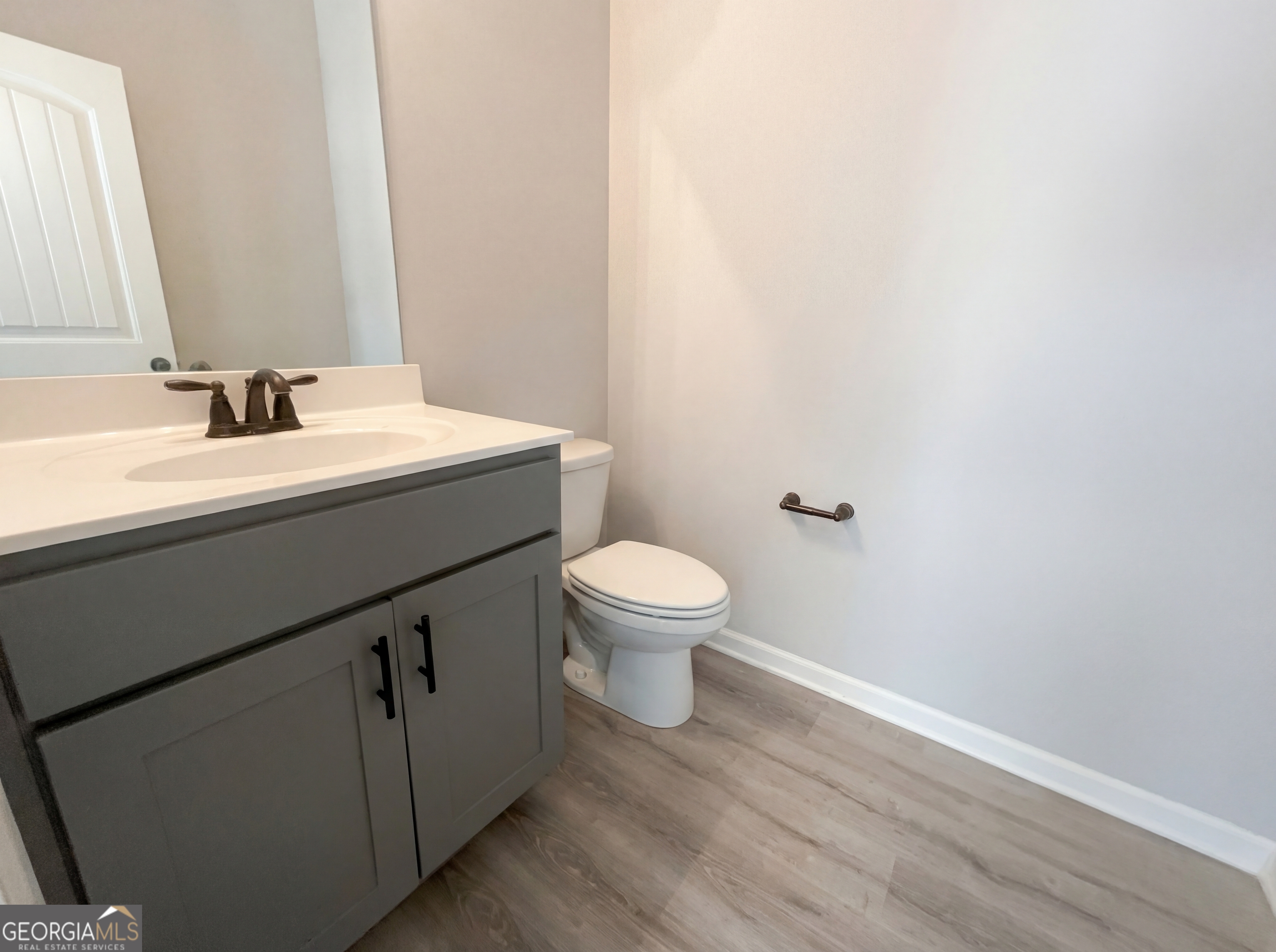 981 Fellowship Road, Unit 108 Fairburn, GA 30213 - Photo 9 of 21 a bathroom with a sink a toilet and mirror