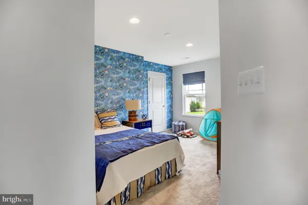 a bedroom with a bed window and wall painting