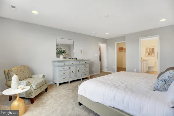 a spacious bedroom with a bed and furniture