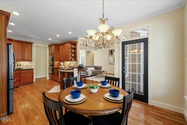 a view of a dining room with furniture large window and wooden floor