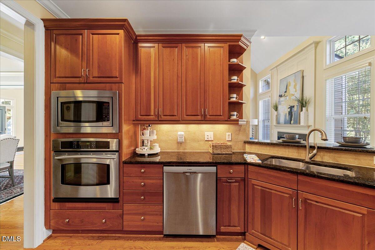 3628 Jamison Park Drive Apex, NC 27539 - Photo 16 of 60 a kitchen with granite countertop a sink and stainless steel appliances