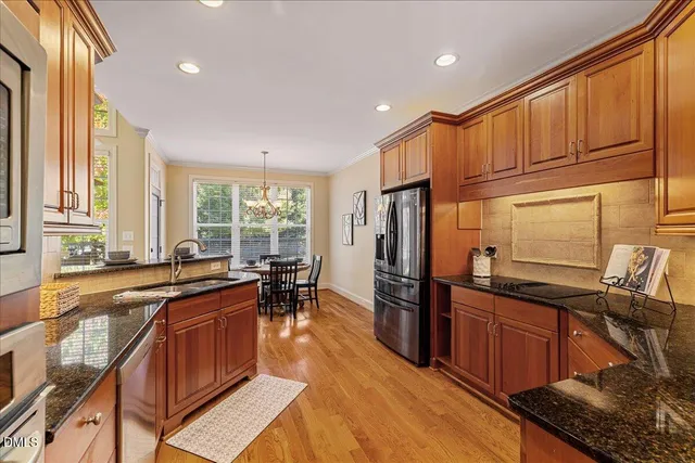 a kitchen with lots of counter top space and stainless steel appliances