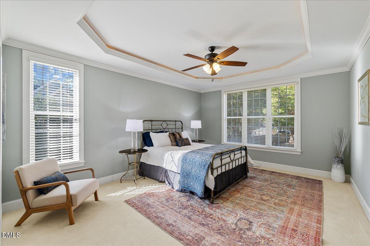 3628 Jamison Park Drive Apex, NC 27539 - Photo 19 of 60 a bedroom with a bed a couch and a window