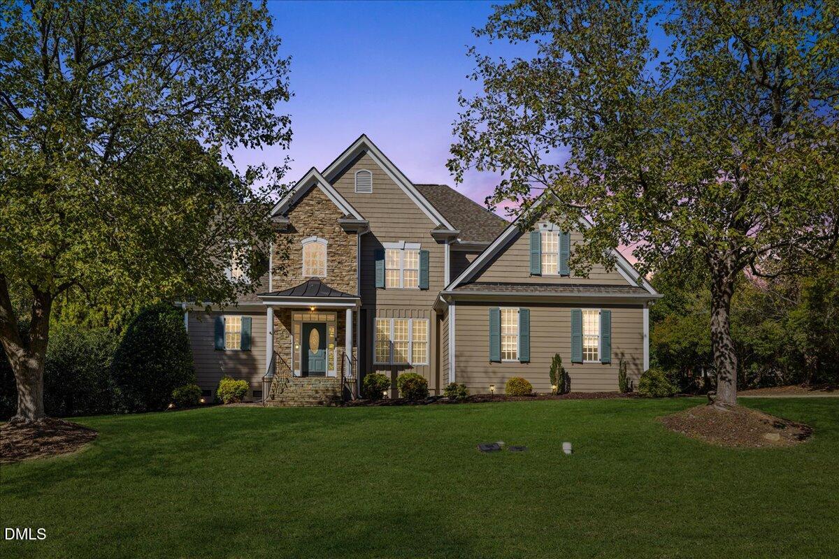 3628 Jamison Park Drive Apex, NC 27539 - Photo 2 of 60 a front view of a house with a garden and trees