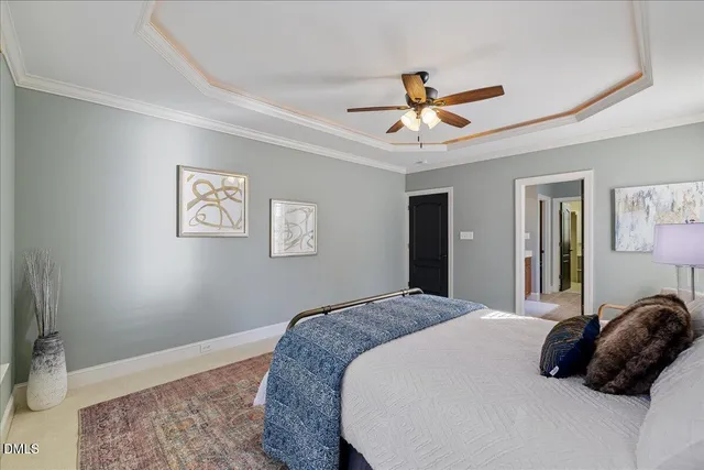 a bedroom with a bed and a ceiling fan