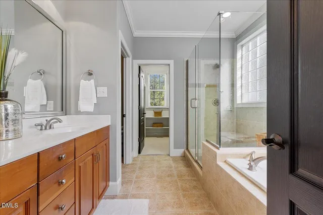 a spacious bathroom with a shower tub double sink and mirror