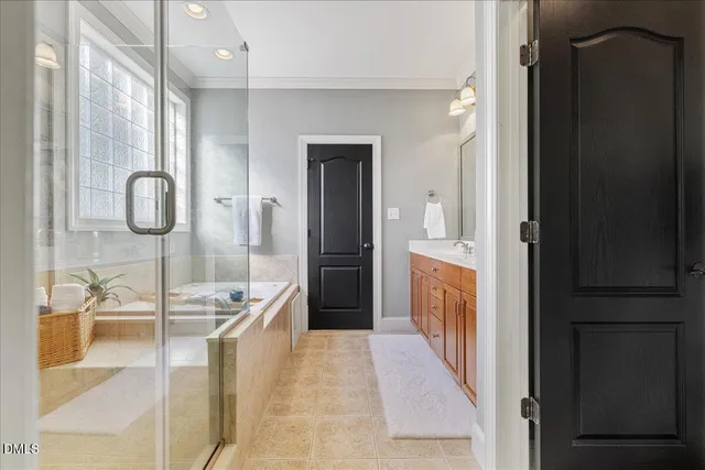 a bathroom with a tub sink and mirror