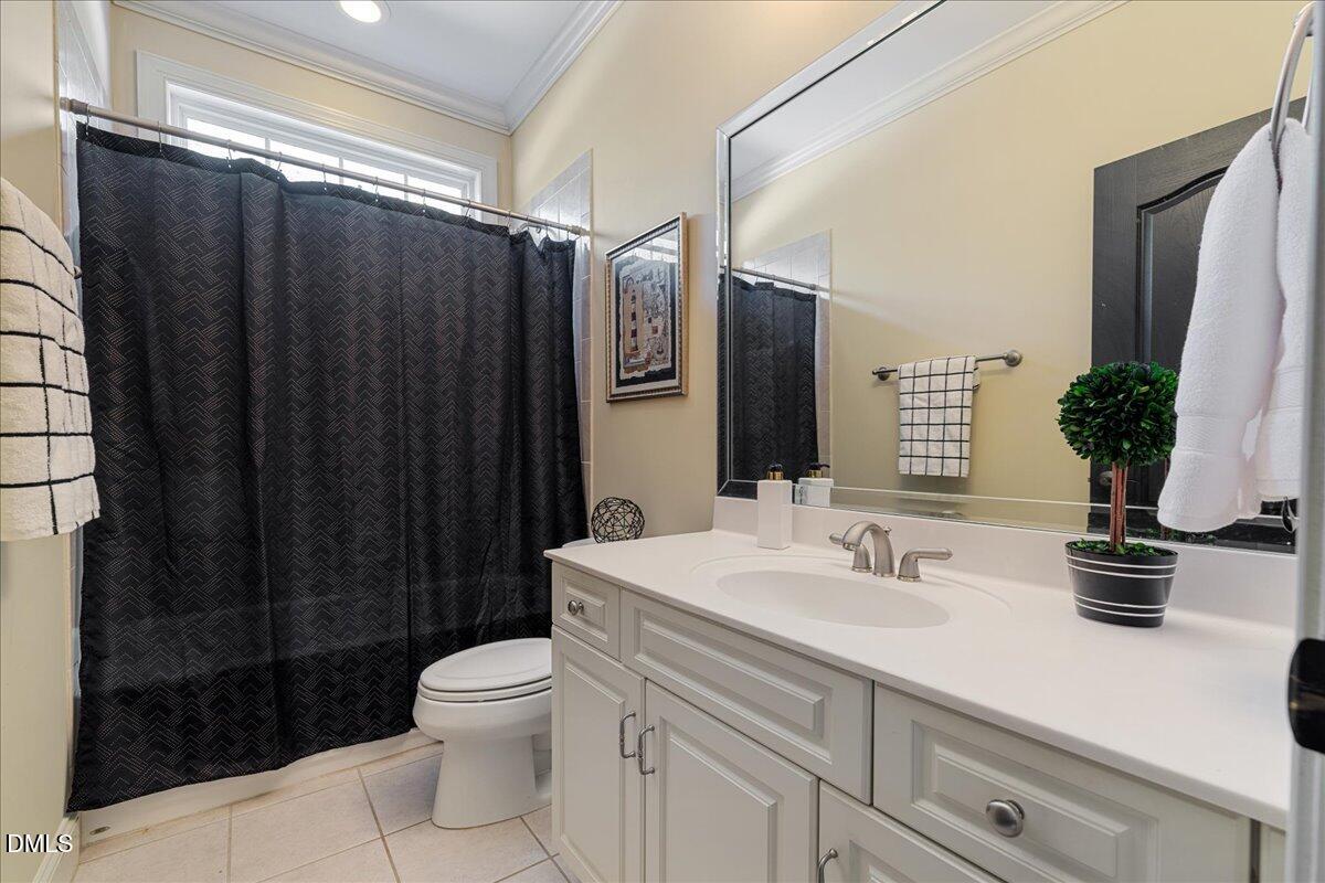 3628 Jamison Park Drive Apex, NC 27539 - Photo 29 of 60 a bathroom with a sink a toilet a mirror and shower