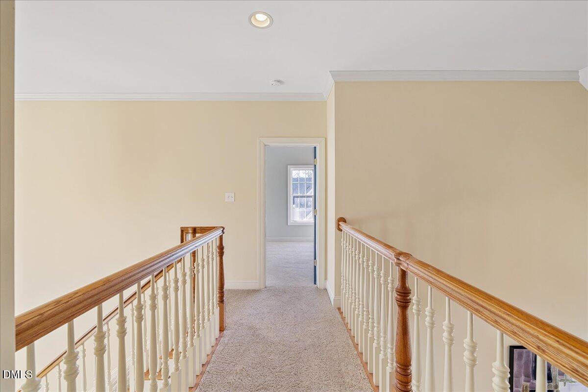 3628 Jamison Park Drive Apex, NC 27539 - Photo 32 of 60 a view of a hallway with wooden floor