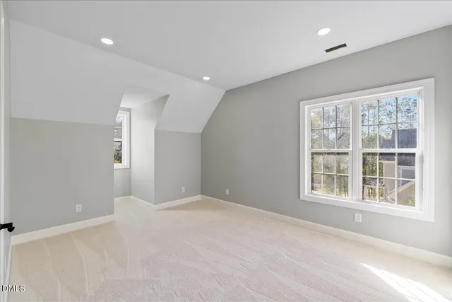 a view of a big room with windows and chandelier fan