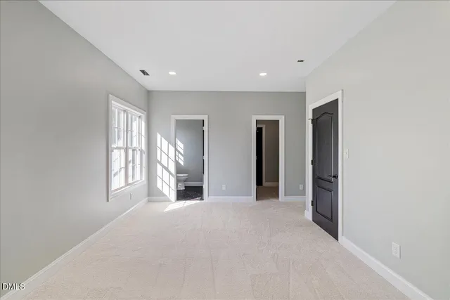 a bathroom with a sink a toilet and a window