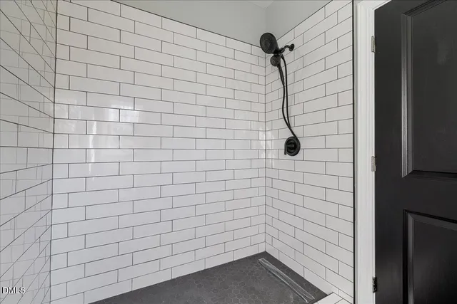a bathroom with a double vanity sink a mirror and shower