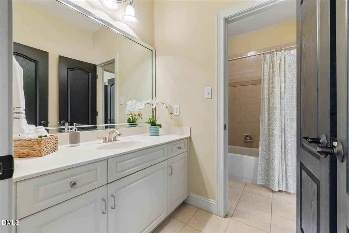 3628 Jamison Park Drive Apex, NC 27539 - Photo 38 of 60 a bathroom with a double vanity sink a mirror and shower