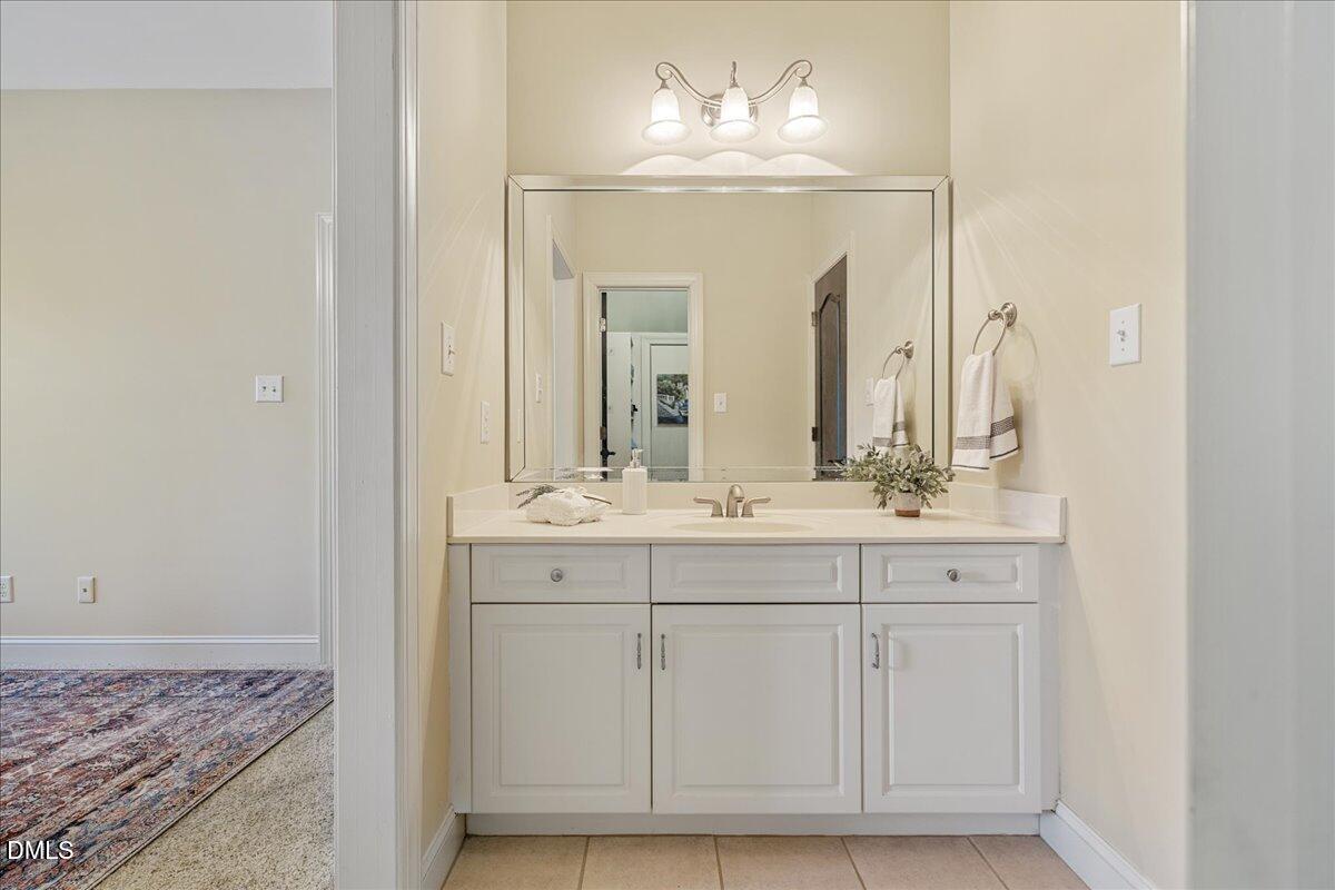 3628 Jamison Park Drive Apex, NC 27539 - Photo 40 of 60 a bathroom with a double vanity sink and a mirror