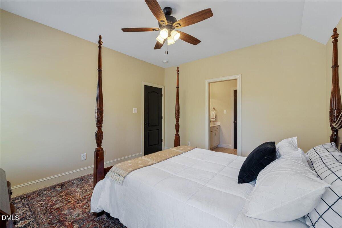 3628 Jamison Park Drive Apex, NC 27539 - Photo 43 of 60 a bedroom with a bed and a ceiling fan