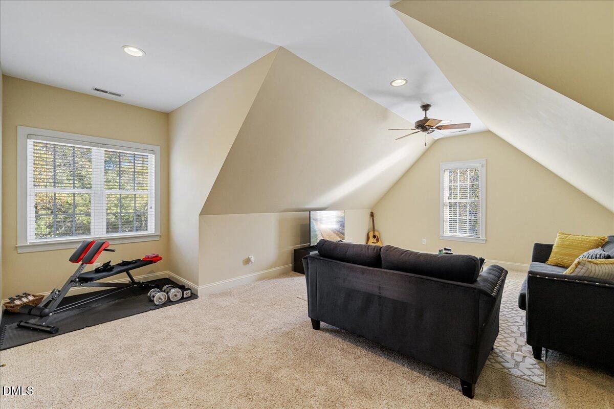 3628 Jamison Park Drive Apex, NC 27539 - Photo 44 of 60 a living room with furniture a flat screen tv and a window