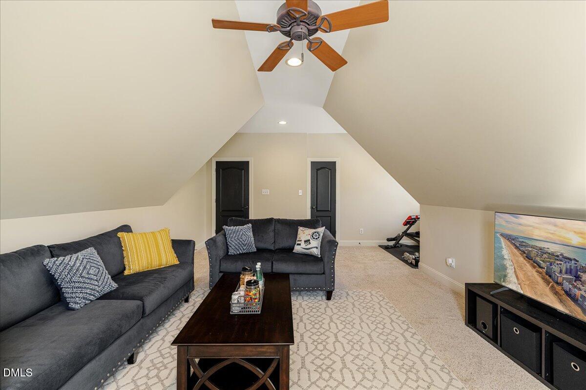 3628 Jamison Park Drive Apex, NC 27539 - Photo 45 of 60 a living room with furniture and a flat screen tv
