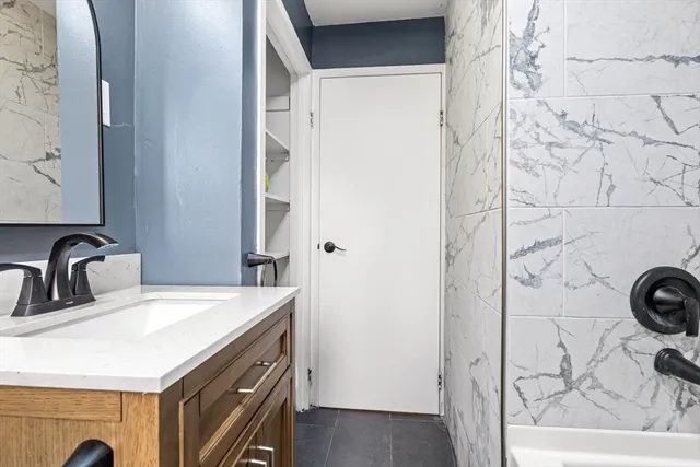 a bathroom with a sink a toilet and a mirror