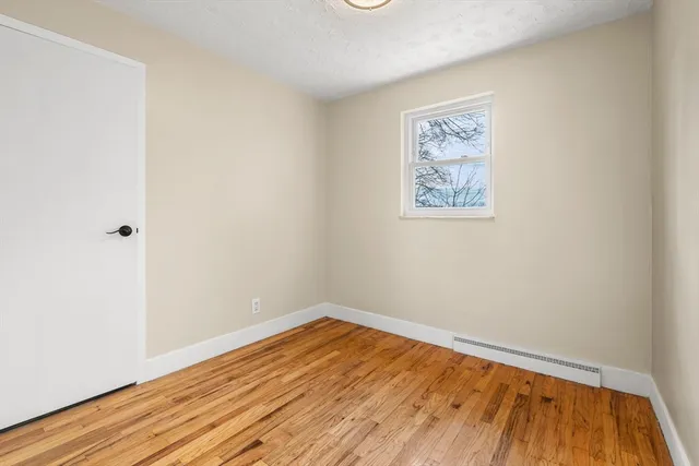 a view of a room with wooden floor