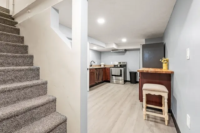 a view of kitchen and hall with wooden floor
