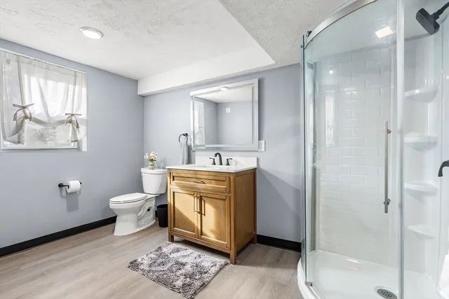 a spacious bathroom with a toilet sink and mirror