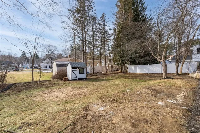 a view of a yard with a house and trees