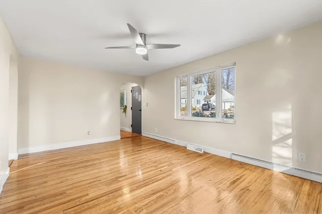 wooden floor in an empty room with a window
