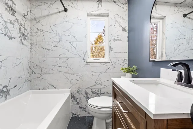 a bathroom with a sink a toilet and bathtub