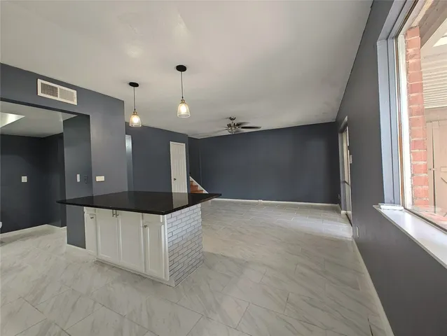 a view of a kitchen with a sink and a window