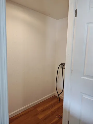 a kitchen with granite countertop a refrigerator and cabinets