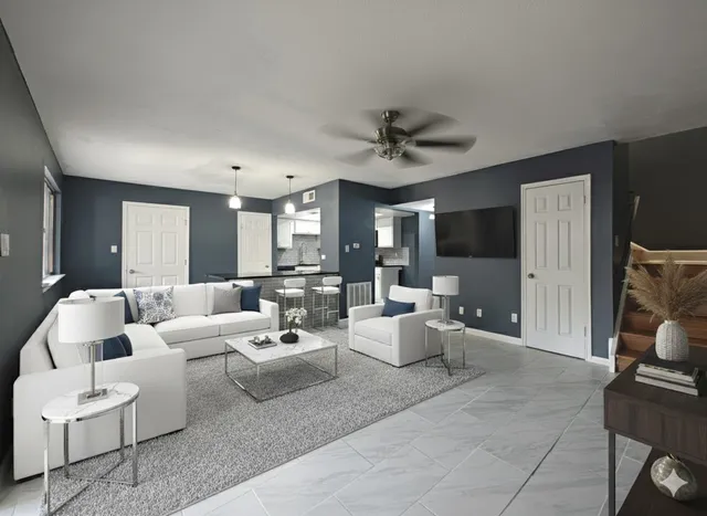 a living room with patio furniture and a fireplace