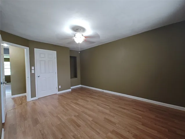 a view of hallway with wooden floor