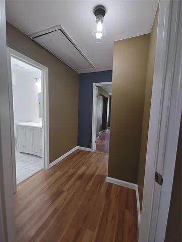 a view of hallway with wooden floor