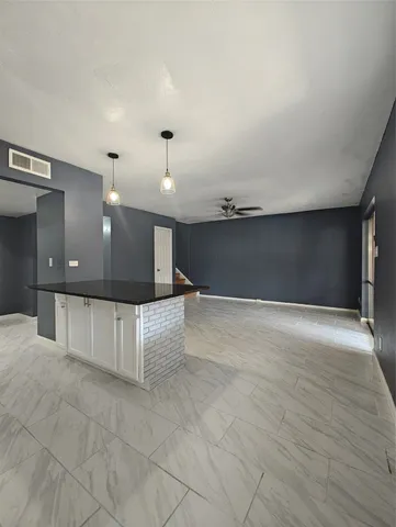 a view of a hall with kitchen