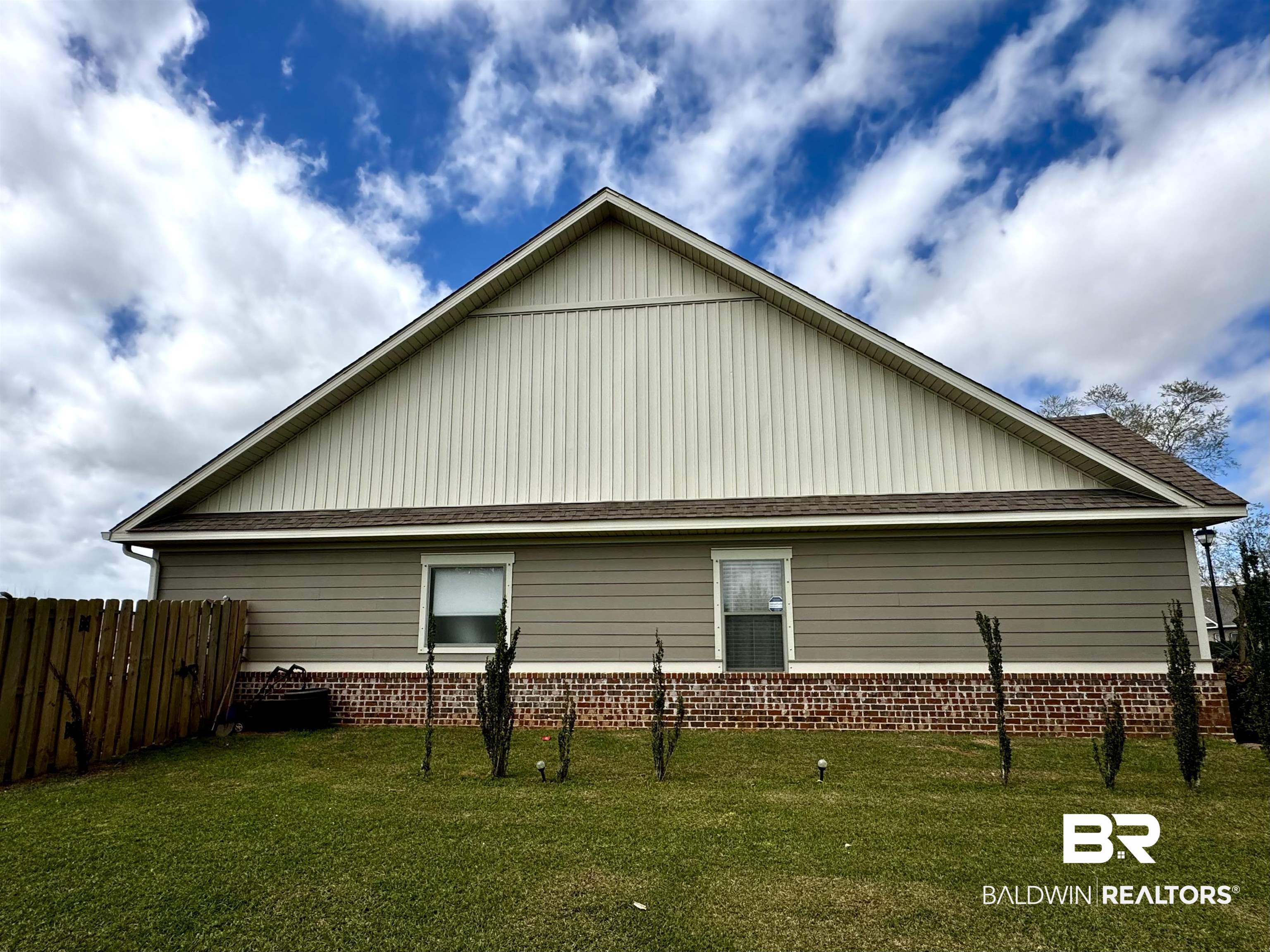 1030 Crown Walk Drive Foley, AL 36535 - Photo 40 of 40 Rear view of property featuring brick siding, a yard, and fence