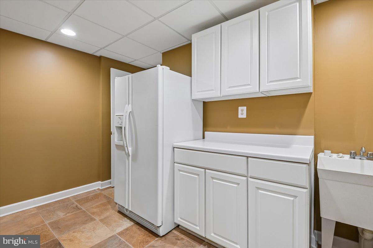2673 Legends Way Ellicott City, MD 21042 - Photo 22 of 36 Refrigerator, cabinets, laundry tub