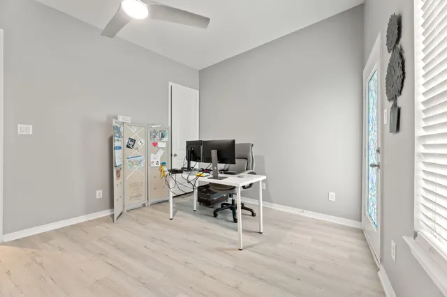 a view of a workspace with furniture and a window