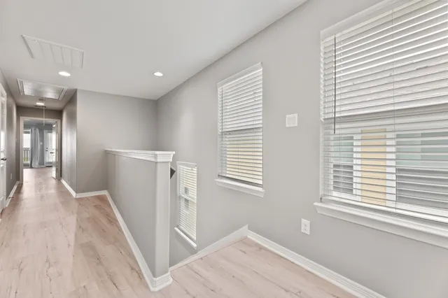 a view of a hallway with windows